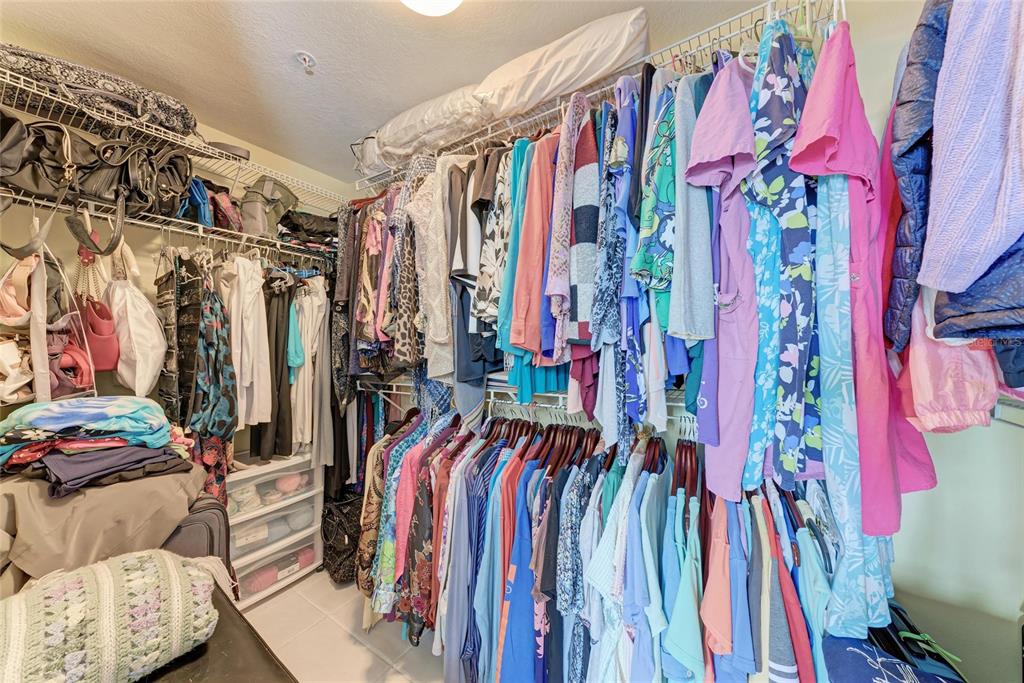 23261 Banbury Way, Unit 501 Venice, FL 34293 - Photo 22 of 75 a view of walk in closet with clothes and shoes