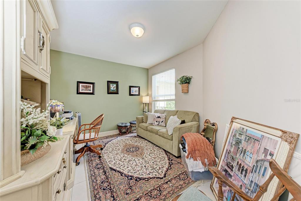 23261 Banbury Way, Unit 501 Venice, FL 34293 - Photo 23 of 75 a living room with furniture and a potted plant