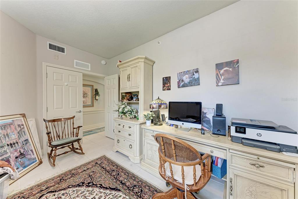 23261 Banbury Way, Unit 501 Venice, FL 34293 - Photo 25 of 75 a living room with furniture and a flat screen tv