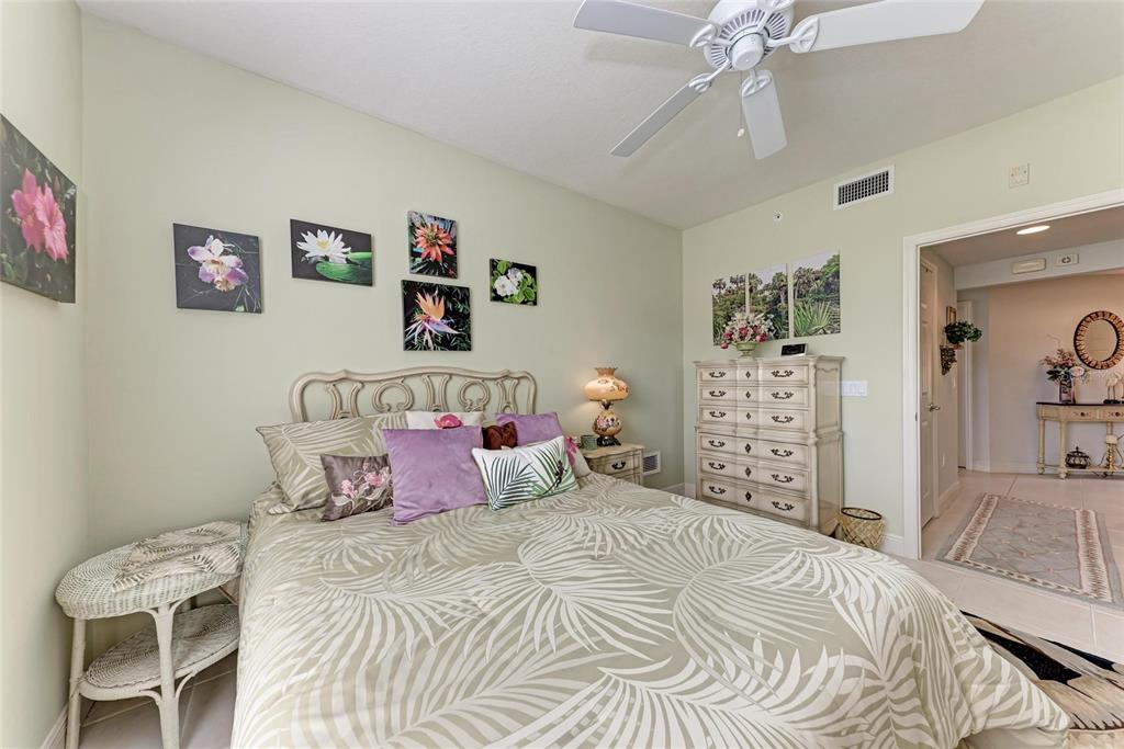 23261 Banbury Way, Unit 501 Venice, FL 34293 - Photo 28 of 75 a bedroom with a bed and a cabinets