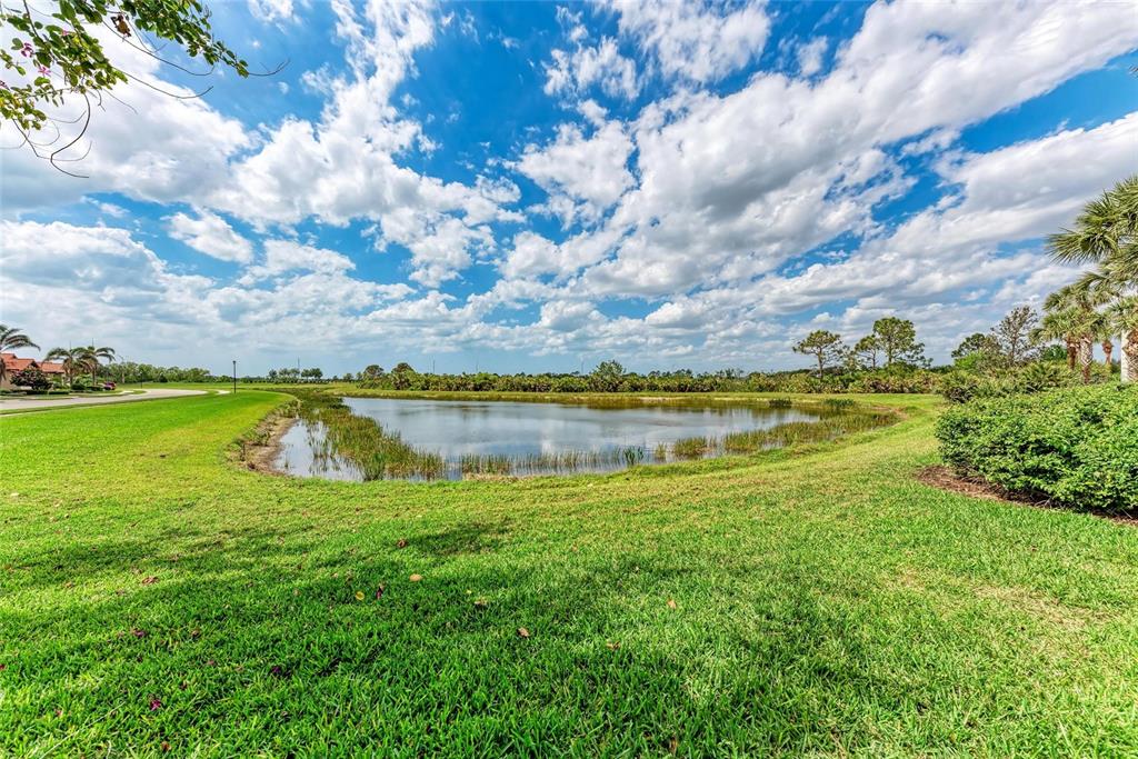 23261 Banbury Way, Unit 501 Venice, FL 34293 - Photo 36 of 75 a view of a lake with a yard