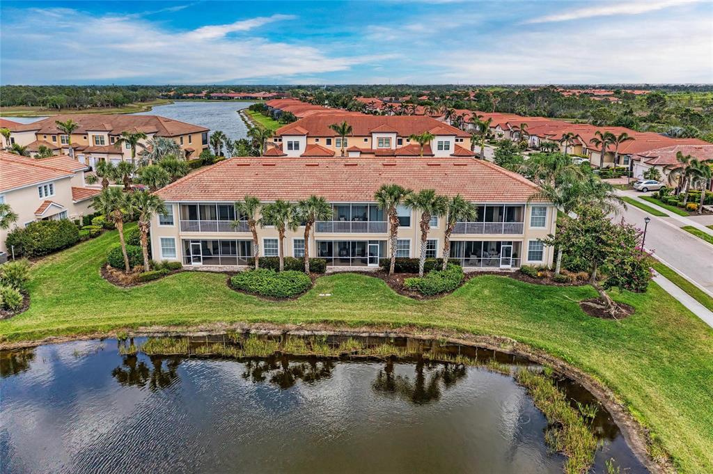 23261 Banbury Way, Unit 501 Venice, FL 34293 - Photo 38 of 75 an aerial view of a house with yard lake view and boat