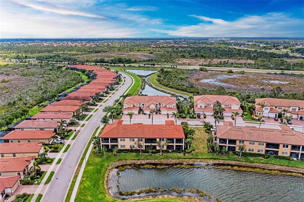 23261 Banbury Way, Unit 501 Venice, FL 34293 - Photo 40 of 75 an aerial view of residential houses with outdoor space