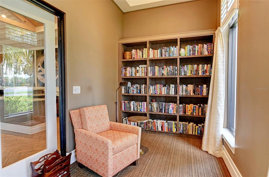 23261 Banbury Way, Unit 501 Venice, FL 34293 - Photo 64 of 75 a living room with furniture and a book shelf