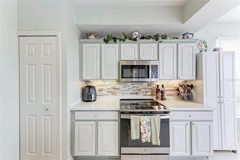 23261 Banbury Way, Unit 501 Venice, FL 34293 - Photo 7 of 75 a kitchen with stainless steel appliances granite countertop a stove and a sink