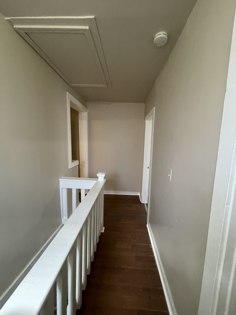 11634 South Princeton Avenue Chicago, IL 60628 - Photo 10 of 18 a view of a hallway with wooden floor and staircase
