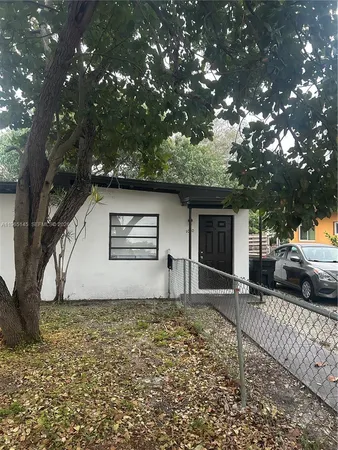 a front view of house with a garden