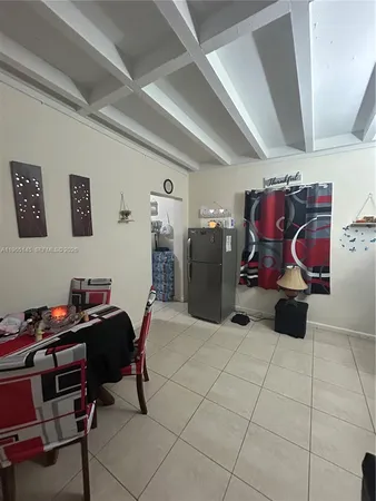 a kitchen with refrigerator and cabinets