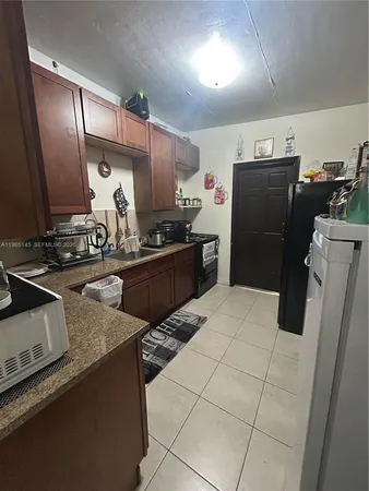 a kitchen with a sink appliances and cabinets