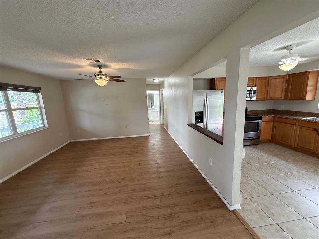 855 Jamaica Road Venice, FL 34293 - Photo 7 of 19 wooden floor in an empty room with a kitchen
