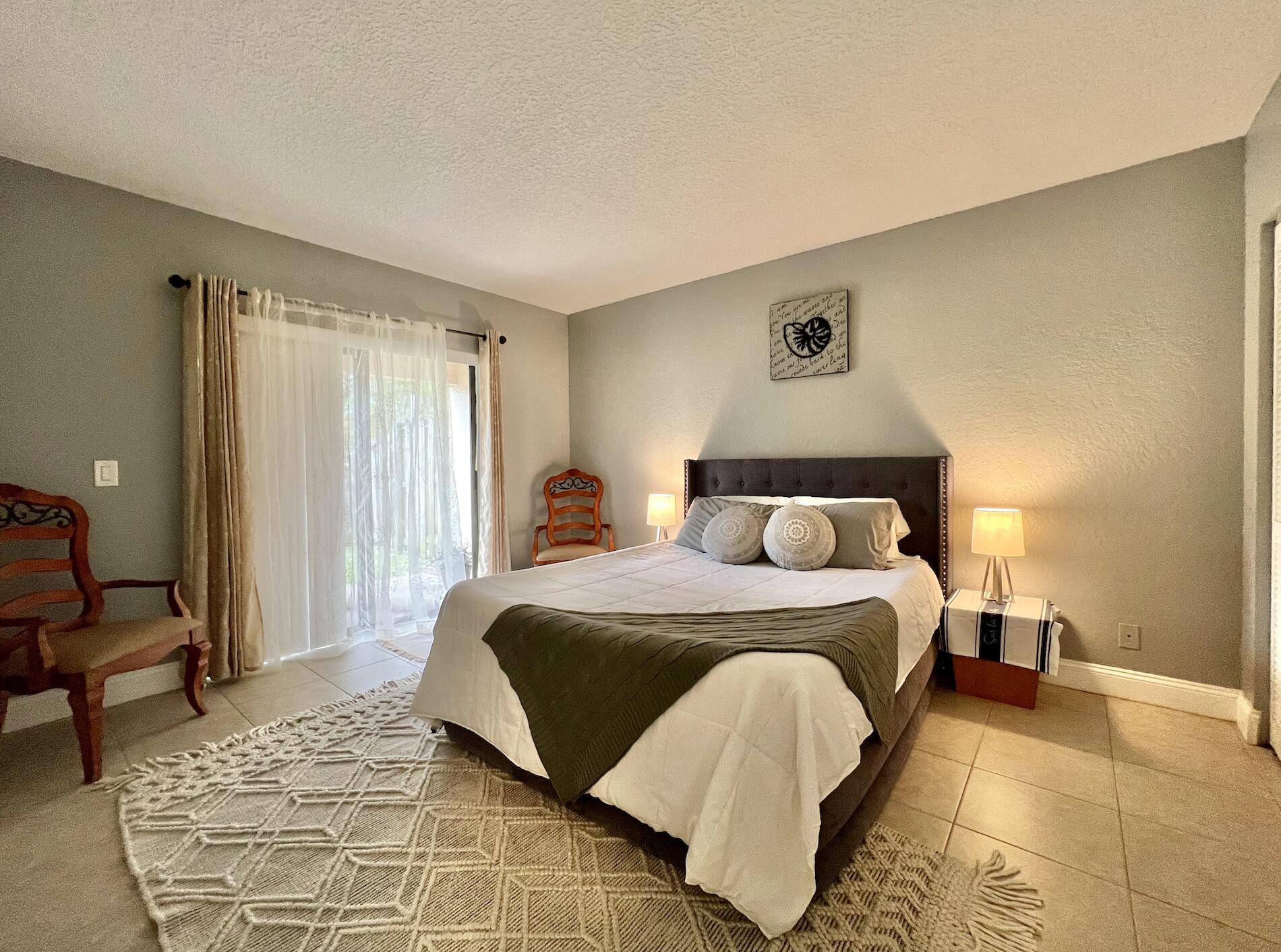 600 Nottingham Circle Greenacres, FL 33463 - Photo 11 of 19 a bedroom with a bed and wooden floor