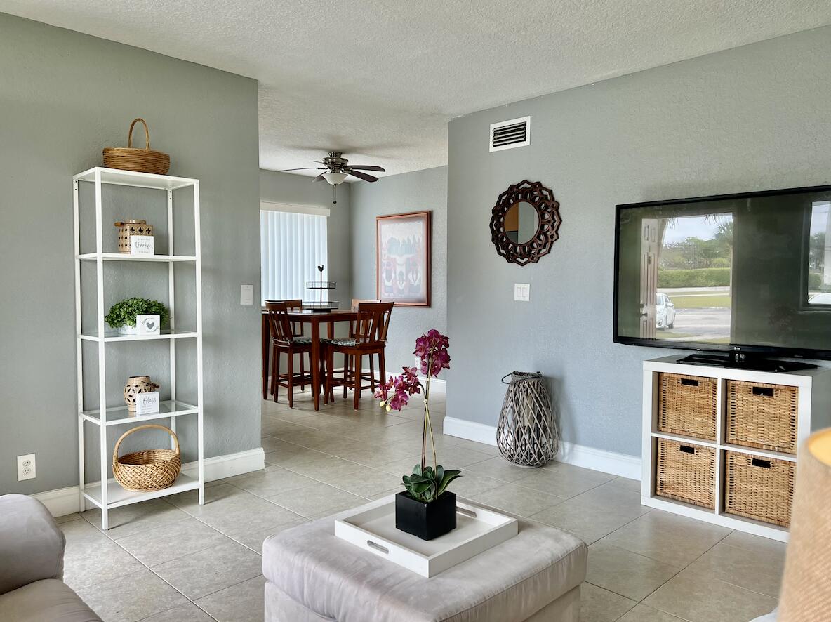 600 Nottingham Circle Greenacres, FL 33463 - Photo 3 of 19 a living room with furniture a rug and a flat screen tv
