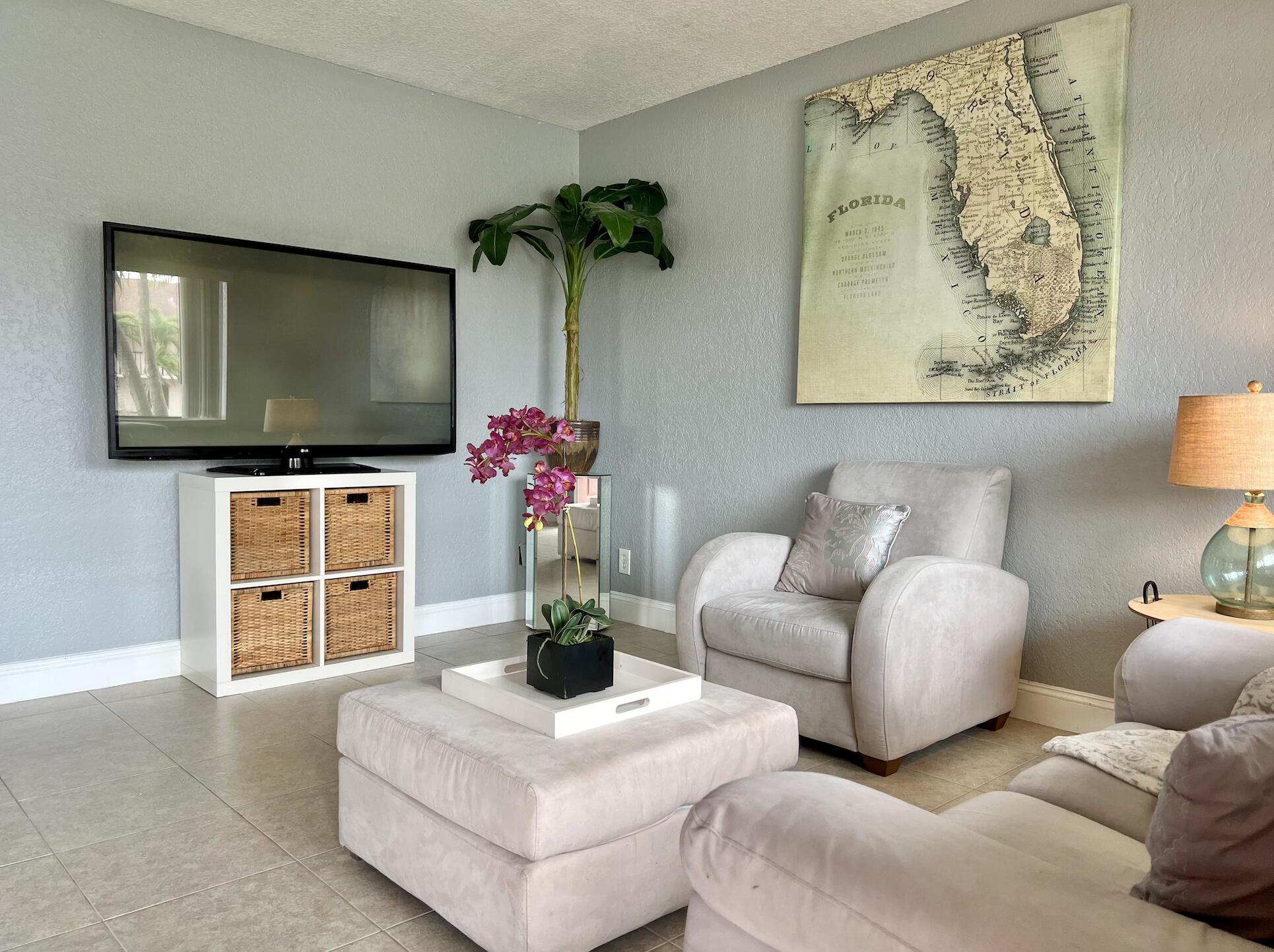 600 Nottingham Circle Greenacres, FL 33463 - Photo 4 of 19 a living room with furniture a chandelier and a flat screen tv