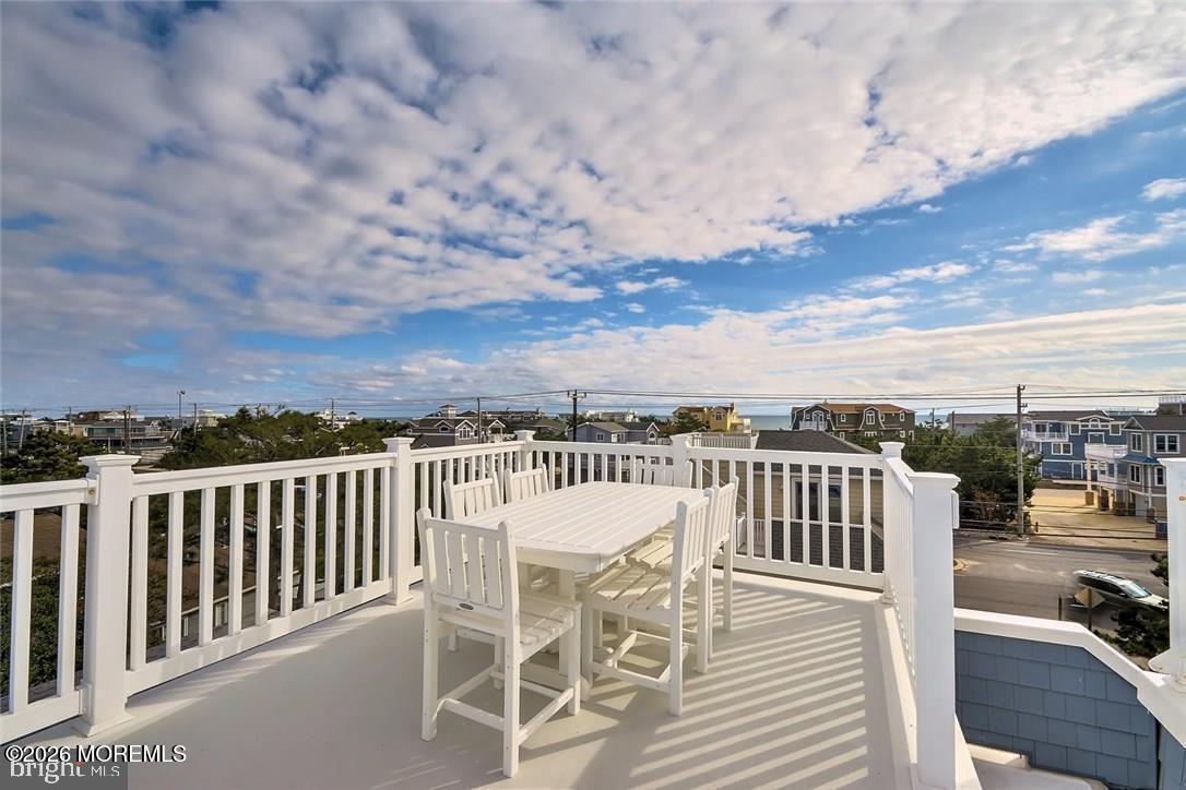 103 Roxie Avenue, Unit A Beach Haven, NJ 08008 - Photo 2 of 33 a view of a balcony with mountain view and wooden floor