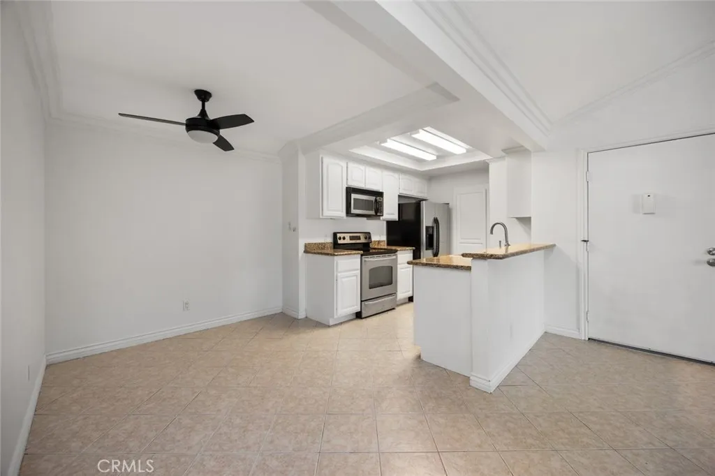 3535 Banbury Drive, Unit 158 Riverside, CA 92501 - Photo 5 of 15 a view of kitchen with microwave and cabinets