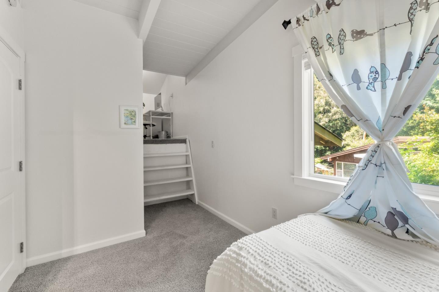 140 Baker Road Aptos, CA 95003 - Photo 35 of 62 a bedroom with a bed and a chandelier