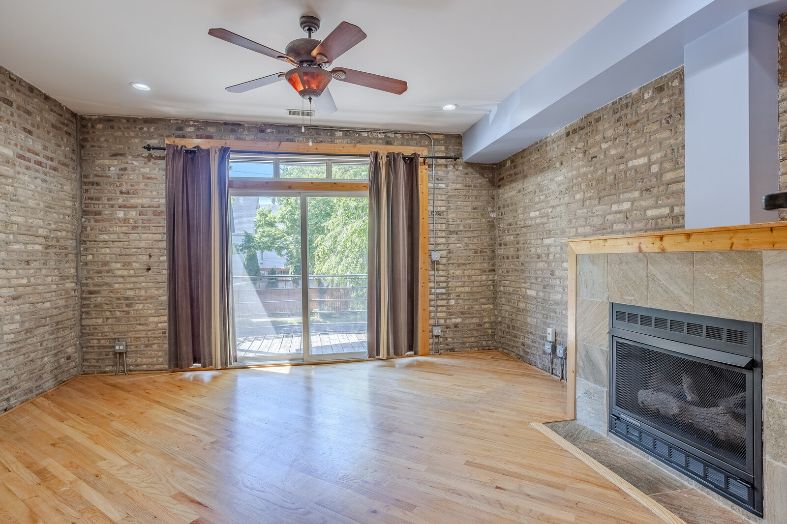 3100 West Addison Street, Unit 1A Chicago, IL 60618 - Photo 11 of 29 a view of an empty room with a fireplace and a window