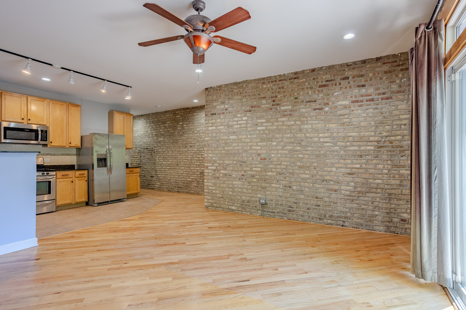 3100 West Addison Street, Unit 1A Chicago, IL 60618 - Photo 12 of 29 a view of a livingroom with kitchen appliances and cabinets