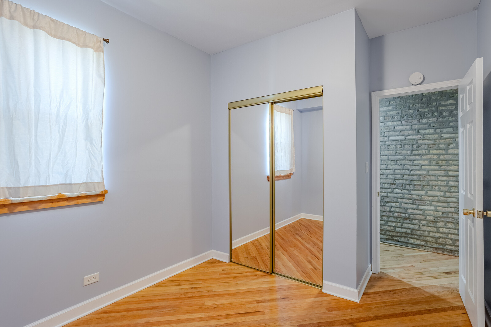 3100 West Addison Street, Unit 1A Chicago, IL 60618 - Photo 20 of 29 a view of a room with wooden floor and bathroom