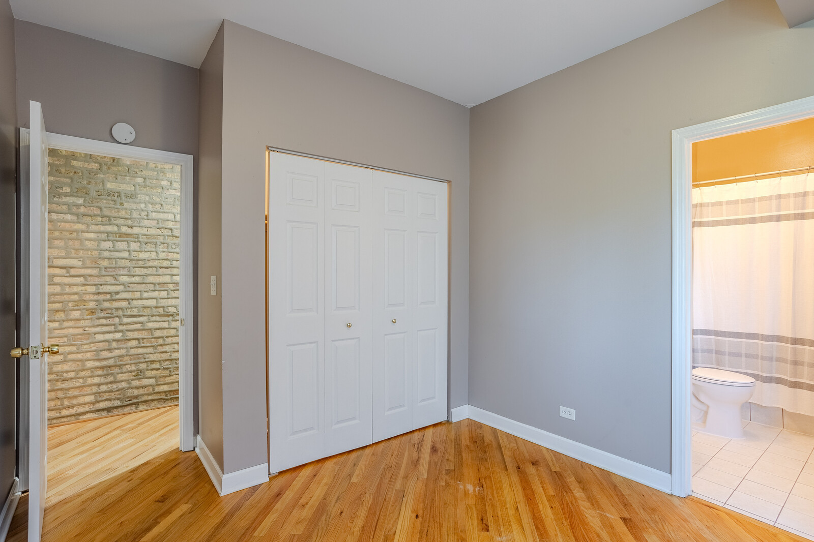 3100 West Addison Street, Unit 1A Chicago, IL 60618 - Photo 22 of 29 a view of empty room with wooden floor