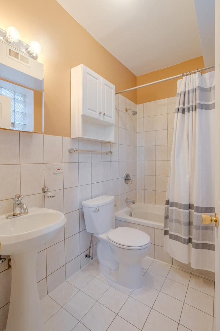 3100 West Addison Street, Unit 1A Chicago, IL 60618 - Photo 23 of 29 a bathroom with a sink toilet and shower