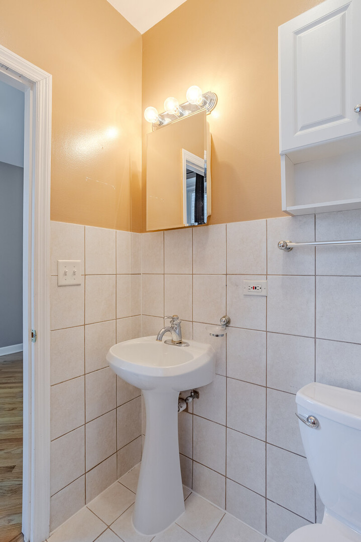 3100 West Addison Street, Unit 1A Chicago, IL 60618 - Photo 24 of 29 a bathroom with a sink toilet and shower
