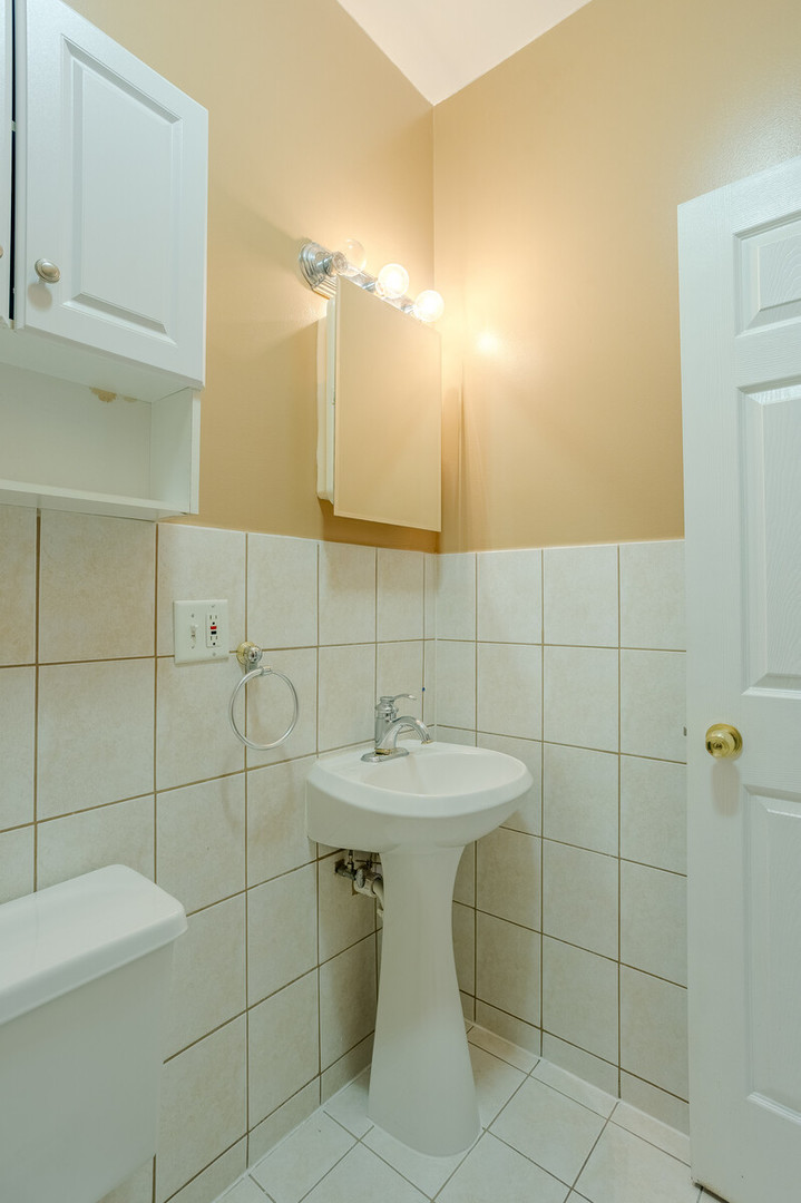 3100 West Addison Street, Unit 1A Chicago, IL 60618 - Photo 25 of 29 a bathroom with a sink toilet and shower
