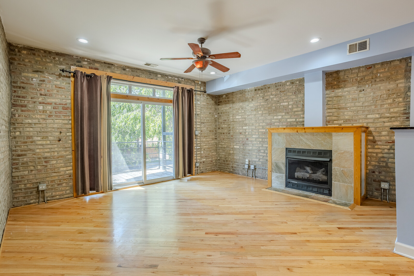 3100 West Addison Street, Unit 1A Chicago, IL 60618 - Photo 5 of 29 a view of an empty room with a fireplace and a window