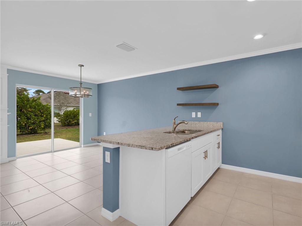 731 Hadley Place West Naples, FL 34104 - Photo 14 of 30 Dining Area With Sliders Leading To The Patio and Kitchen Island With Granite Countertop And Sink