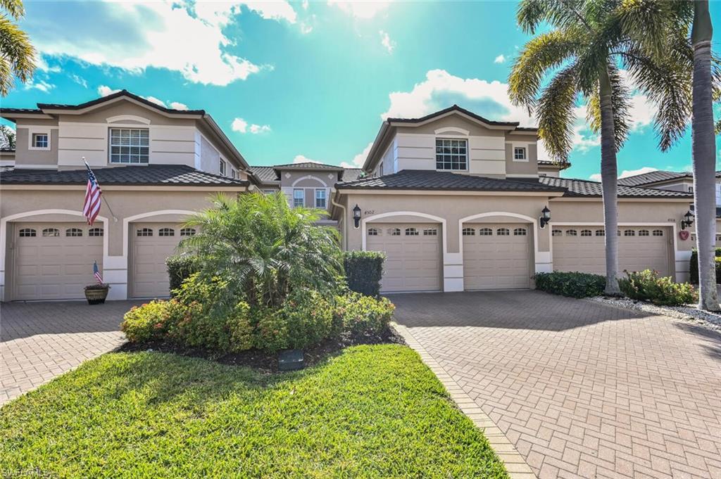 793 Regency Reserve Circle, Unit 4502 Naples, FL 34119 - Photo 1 of 24 a front view of a house with a yard and garage