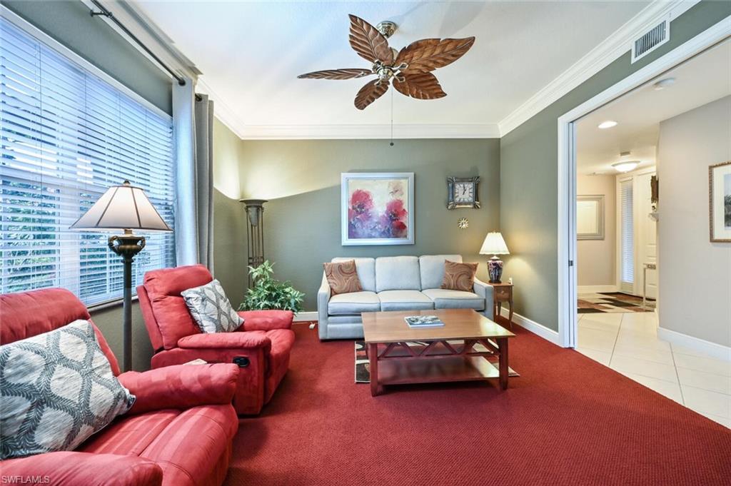 793 Regency Reserve Circle, Unit 4502 Naples, FL 34119 - Photo 12 of 24 a living room with furniture and a large window