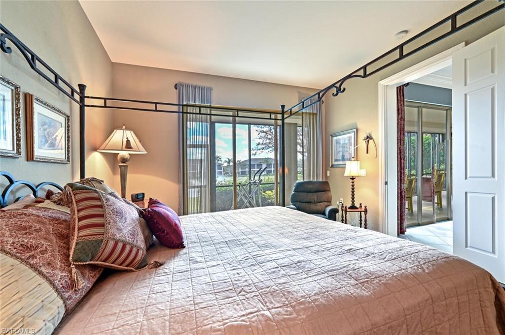793 Regency Reserve Circle, Unit 4502 Naples, FL 34119 - Photo 14 of 24 a bedroom with a large bed and a large window
