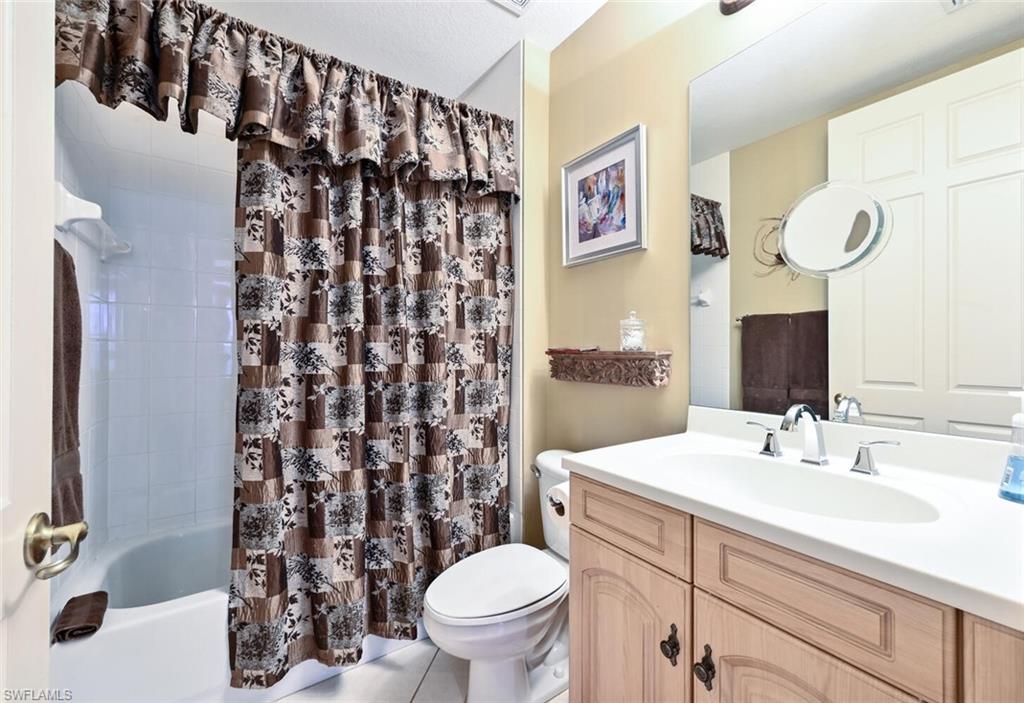 793 Regency Reserve Circle, Unit 4502 Naples, FL 34119 - Photo 17 of 24 a bathroom with a sink toilet and shower