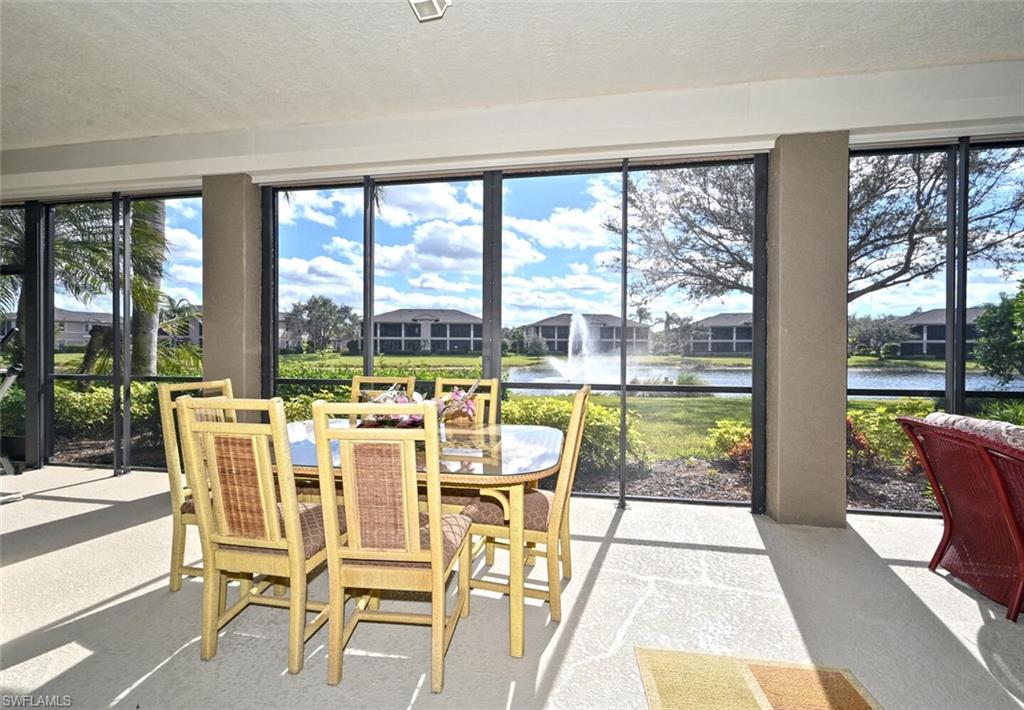 793 Regency Reserve Circle, Unit 4502 Naples, FL 34119 - Photo 19 of 24 a dining room with furniture and large windows