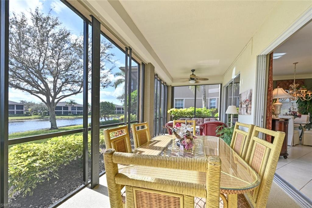 793 Regency Reserve Circle, Unit 4502 Naples, FL 34119 - Photo 20 of 24 a view of a dining room with furniture a chandelier and large windows