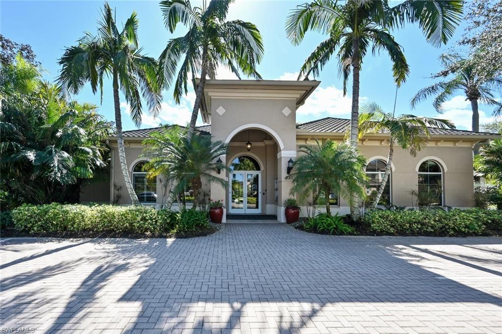 793 Regency Reserve Circle, Unit 4502 Naples, FL 34119 - Photo 21 of 24 a front view of a house with a garden