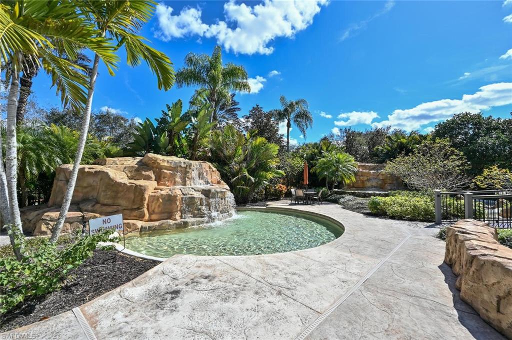 793 Regency Reserve Circle, Unit 4502 Naples, FL 34119 - Photo 22 of 24 a view of a garden with a house