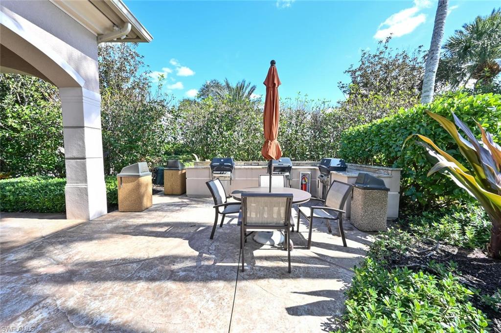 793 Regency Reserve Circle, Unit 4502 Naples, FL 34119 - Photo 24 of 24 a view of a patio with a table and chairs and potted plants