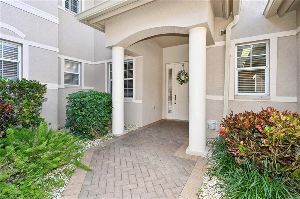 793 Regency Reserve Circle, Unit 4502 Naples, FL 34119 - Photo 3 of 24 front view of a house with a yard