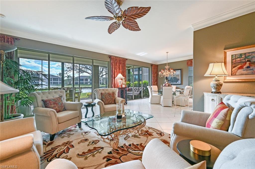 793 Regency Reserve Circle, Unit 4502 Naples, FL 34119 - Photo 5 of 24 a living room with furniture ceiling fan and a rug