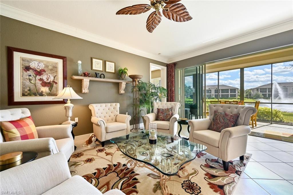 793 Regency Reserve Circle, Unit 4502 Naples, FL 34119 - Photo 6 of 24 a living room with furniture and a large window