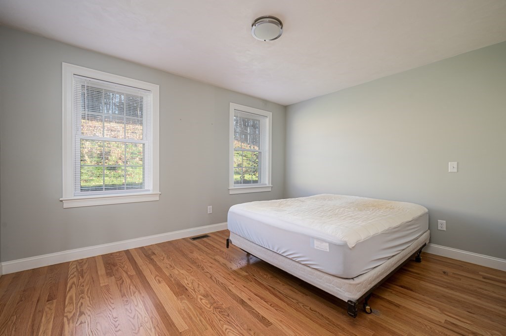 5 Turtle Lane, Unit 5 Sterling, MA 01564 - Photo 14 of 30 a bed sitting in a bedroom next to a window