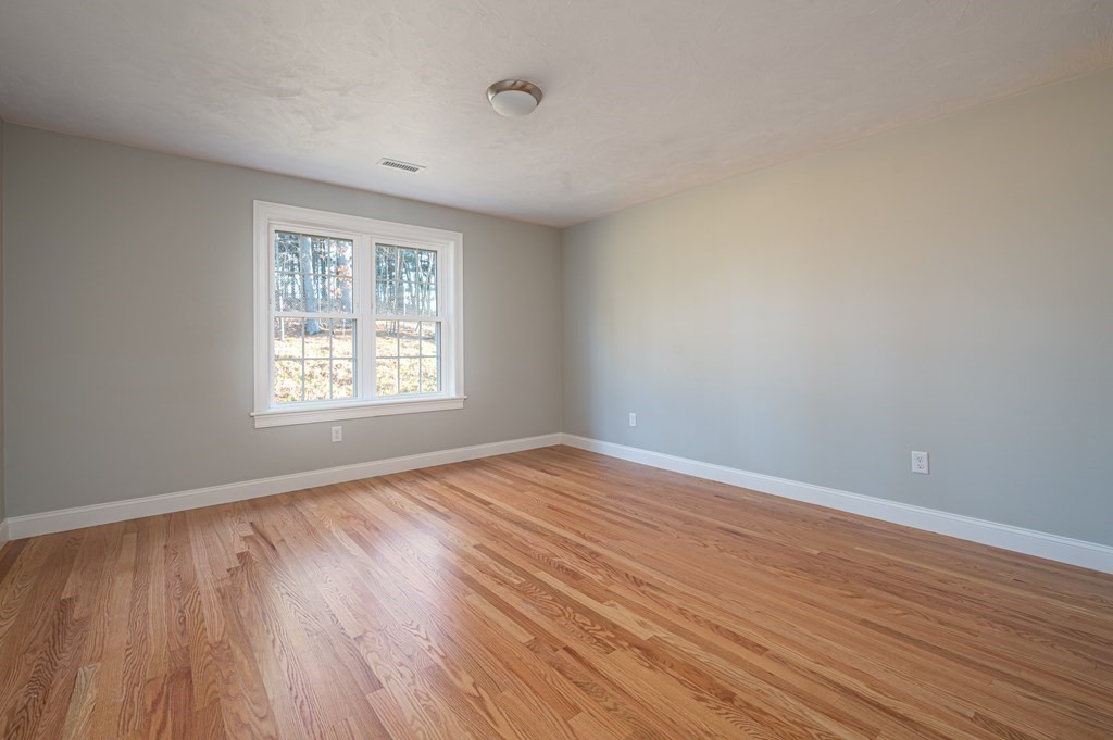 5 Turtle Lane, Unit 5 Sterling, MA 01564 - Photo 19 of 30 an empty room with wooden floor and windows