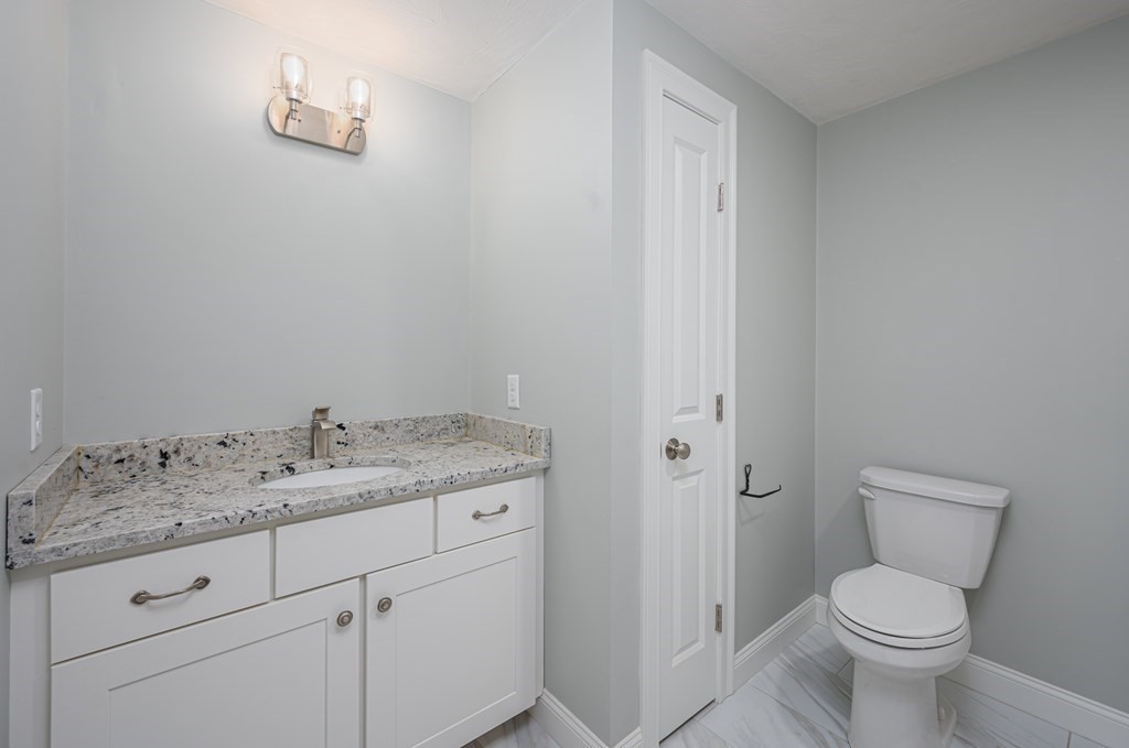 5 Turtle Lane, Unit 5 Sterling, MA 01564 - Photo 22 of 30 a bathroom with a granite countertop toilet and sink
