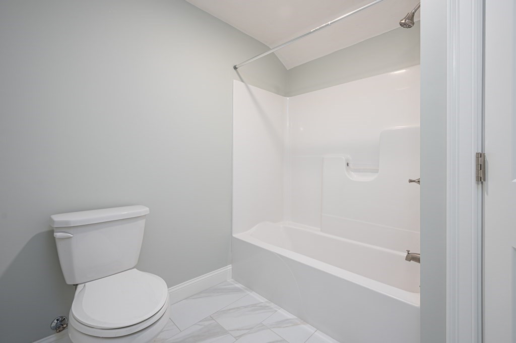 5 Turtle Lane, Unit 5 Sterling, MA 01564 - Photo 23 of 30 a white toilet sitting next to a bath tub