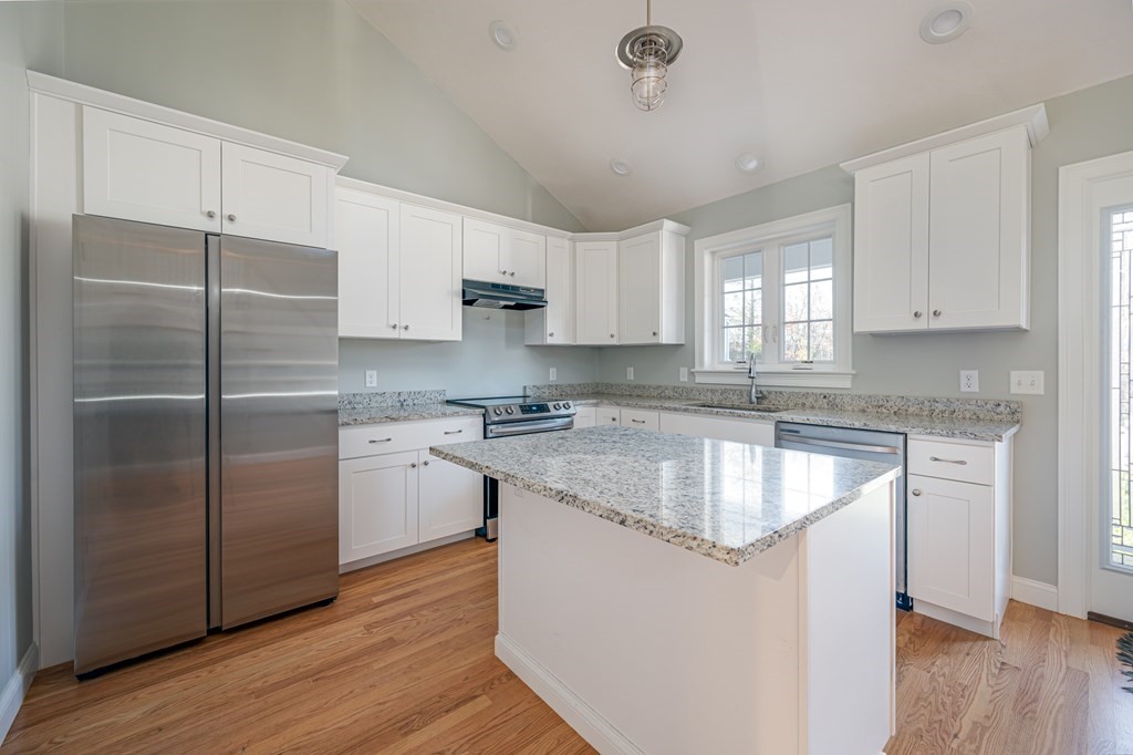 5 Turtle Lane, Unit 5 Sterling, MA 01564 - Photo 5 of 30 a kitchen with stainless steel appliances granite countertop a refrigerator a sink dishwasher a stove and white countertops with wooden floor