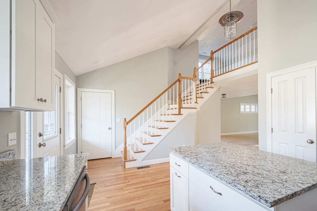 5 Turtle Lane, Unit 5 Sterling, MA 01564 - Photo 7 of 30 a view of staircase with kitchen island sink and wooden floor