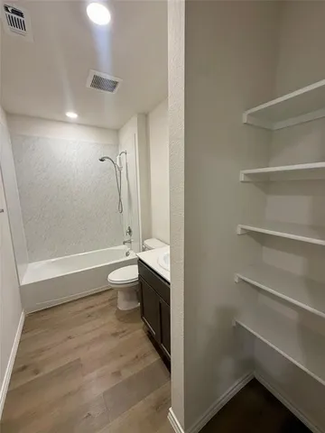 a bathroom with a toilet a sink and bathtub