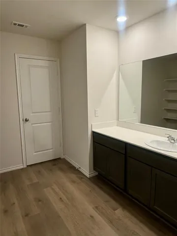 a bathroom with a double vanity sink and mirror