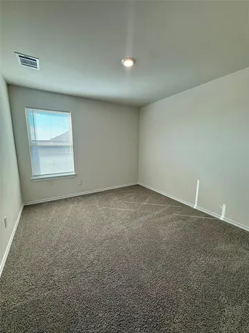 an empty room with a empty space and windows